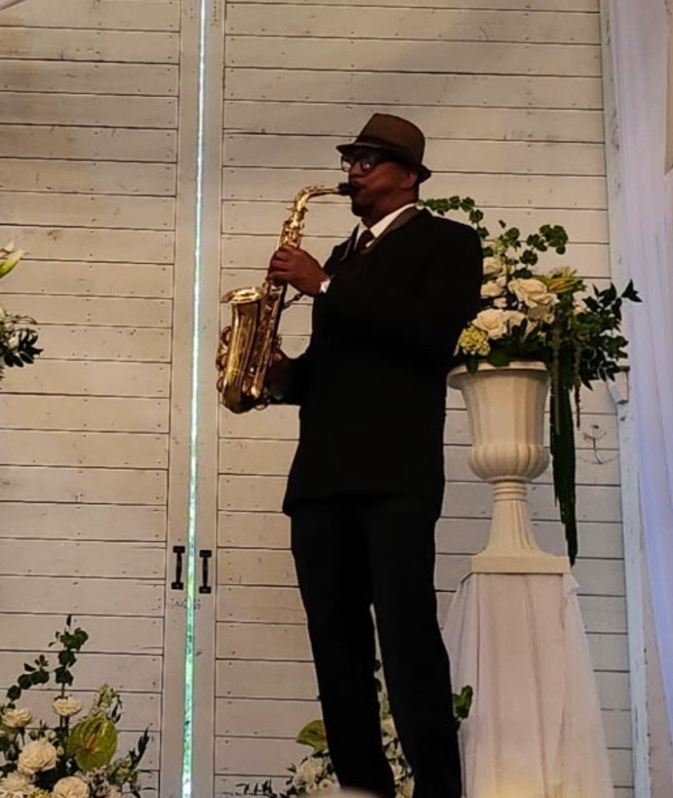 Carlos playing sax at a wedding ceremony